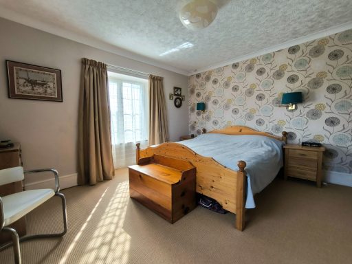 Large, double-aspect master bedroom, with windows facing south and east