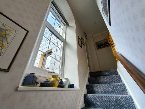 The stairway is well lit by a large window